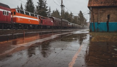 outdoors,sky,day,cloud,water,tree,no humans,grass,plant,ground vehicle,nature,scenery,motor vehicle,reflection,rain,sign,road,power lines,utility pole,puddle,train,train station,railroad tracks,cloudy sky,building,realistic,grey sky