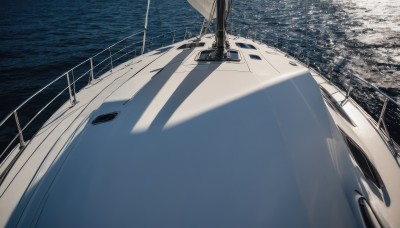 outdoors,day,water,no humans,shadow,ocean,building,scenery,fence,railing,road,watercraft,vehicle focus,ship,boat,dock