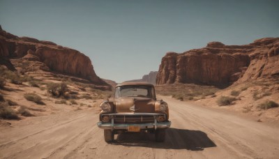 outdoors,sky,day,blue sky,no humans,shadow,ground vehicle,scenery,motor vehicle,sand,car,road,vehicle focus,desert,truck,rock,driving,dust,sports car