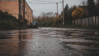 outdoors,sky,day,cloud,water,tree,no humans,window,grass,ground vehicle,building,scenery,motor vehicle,reflection,rain,fence,road,bush,house,power lines,street,utility pole,puddle,realistic,bare tree