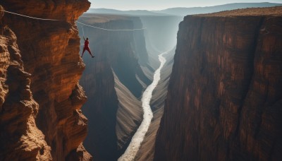 solo,1boy,standing,male focus,outdoors,sky,day,water,from behind,cape,scenery,1other,rock,mountain,ambiguous gender,cliff,cave,1girl,landscape