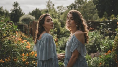 long hair,looking at viewer,multiple girls,brown hair,dress,2girls,bare shoulders,brown eyes,jewelry,flower,earrings,outdoors,parted lips,day,white dress,blurry,tree,lips,depth of field,blurry background,holding hands,siblings,nature,realistic,orange flower,garden,smile,open mouth,upper body,looking at another,blue dress,plant,sisters,mother and daughter