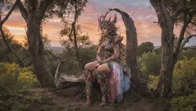 1girl,solo,long hair,breasts,blue eyes,brown hair,hair ornament,dress,cleavage,jewelry,medium breasts,sitting,flower,boots,outdoors,sky,barefoot,cloud,armor,tree,grass,plant,nature,scenery,forest,sunset,fantasy,braid,bracelet,helmet,shoulder armor,headdress