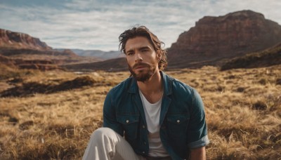 solo,looking at viewer,short hair,brown hair,shirt,1boy,sitting,closed mouth,jacket,white shirt,short sleeves,male focus,outdoors,open clothes,sky,day,pants,cloud,blurry,open jacket,facial hair,grass,denim,blue jacket,beard,knee up,pocket,striped shirt,mountain,realistic,stubble,field,mountainous horizon,denim jacket,brown eyes,jeans