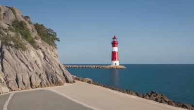 outdoors,sky,day,water,tree,blue sky,no humans,ocean,beach,building,scenery,rock,sand,horizon,road,tower,landscape,shore,cliff,lighthouse,island