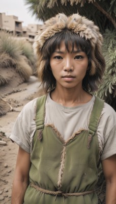 1girl,solo,looking at viewer,short hair,bangs,brown hair,shirt,black hair,hat,brown eyes,white shirt,upper body,short sleeves,outdoors,parted lips,day,blurry,black eyes,tree,lips,blurry background,t-shirt,building,freckles,realistic,nose,arms at sides,straw hat,overalls,dirty,photo background,dress,hood,fur trim,hood up