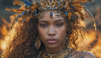 1girl,solo,long hair,looking at viewer,brown hair,hair ornament,bare shoulders,brown eyes,jewelry,closed mouth,earrings,dark skin,necklace,blurry,dark-skinned female,lips,eyelashes,blurry background,wavy hair,fire,feathers,portrait,freckles,curly hair,hoop earrings,realistic,headdress,gold,gem,feather hair ornament