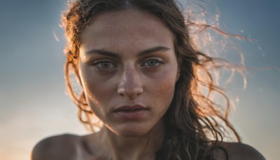 1girl,solo,long hair,looking at viewer,brown hair,black hair,brown eyes,parted lips,sky,blurry,lips,grey eyes,messy hair,portrait,backlighting,freckles,realistic,mole on cheek,closed mouth,mole,blue sky,floating hair,blurry background,expressionless,sunlight,wind,close-up,forehead,dirty,dirty face