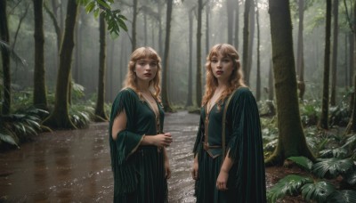 long hair,breasts,looking at viewer,multiple girls,blonde hair,brown hair,long sleeves,dress,2girls,cleavage,brown eyes,jewelry,medium breasts,standing,outdoors,parted lips,day,wide sleeves,necklace,tree,siblings,wavy hair,own hands together,plant,sisters,nature,forest,green dress,twins,realistic,red lips,open mouth,bangs,blue eyes,mole,lips,makeup,sunlight,scenery,path