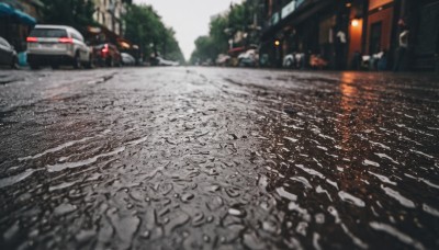 outdoors,blurry,tree,no humans,depth of field,blurry background,ground vehicle,building,scenery,motor vehicle,city,realistic,car,road,lamppost,street,photo background,real world location,sky,day,window