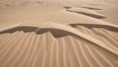 monochrome,outdoors,no humans,beach,sunlight,scenery,sand,sepia,brown theme,desert,bed sheet,close-up,still life