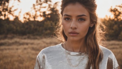 1girl,solo,long hair,looking at viewer,brown hair,shirt,brown eyes,jewelry,closed mouth,white shirt,upper body,earrings,outdoors,dark skin,necklace,blurry,dark-skinned female,lips,depth of field,blurry background,freckles,realistic,nose,day,eyelashes,makeup,sunlight,thick eyebrows,portrait,backlighting,photo background