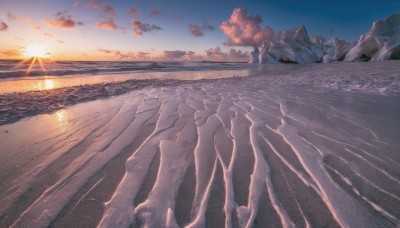 outdoors,sky,day,cloud,water,tree,blue sky,dutch angle,no humans,ocean,beach,sunlight,cloudy sky,scenery,sunset,rock,mountain,sand,sun,horizon,landscape,gradient sky,shore,sunrise,desert,solo,reflection,waves