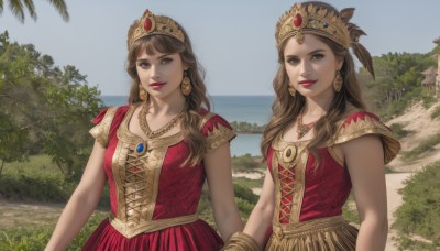 long hair,looking at viewer,smile,multiple girls,brown hair,hair ornament,dress,2girls,brown eyes,jewelry,upper body,short sleeves,earrings,outdoors,parted lips,sky,sleeveless,day,water,necklace,tree,blue sky,lips,siblings,ocean,beach,red dress,feathers,crown,sisters,gem,twins,realistic,palm tree,headdress,red lips,feather hair ornament,breasts,bangs,medium breasts,teeth,makeup,sleeveless dress,grass