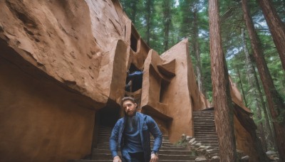 solo,brown hair,black hair,1boy,jacket,male focus,outdoors,day,tree,facial hair,nature,scenery,beard,forest,stairs,realistic,mustache,jumpsuit,statue,looking at viewer,short hair,shirt,long sleeves,pants,bag,backpack,blue shirt,blue jacket,rock,ruins,denim jacket