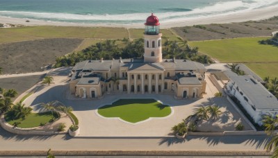 outdoors,sky,day,water,tree,no humans,shadow,ocean,beach,grass,plant,ground vehicle,building,scenery,sand,palm tree,road,shade,watercraft,bridge,river,tower,boat,shore,cloud,nature,bush,castle,ship,waves,landscape,lighthouse