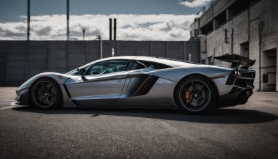 outdoors,sky,day,cloud,no humans,shadow,cloudy sky,ground vehicle,building,scenery,motor vehicle,car,road,vehicle focus,power lines,lamppost,street,utility pole,wheel,sports car,solo