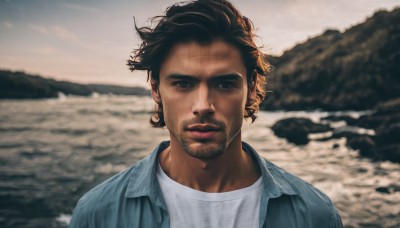 solo,looking at viewer,short hair,brown hair,shirt,1boy,closed mouth,jacket,white shirt,upper body,male focus,outdoors,open clothes,blurry,black eyes,blurry background,facial hair,beach,blue jacket,messy hair,portrait,beard,realistic,mustache,stubble,photo background,denim jacket,black hair,brown eyes,sky,dark skin,water,lips,depth of field,ocean,dark-skinned male,blue shirt,sunset