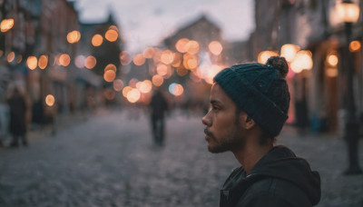 solo, black hair, 1boy, hat, jacket, upper body, male focus, outdoors, hood, blurry, from side, profile, depth of field, blurry background, facial hair, hood down, beard, realistic, beanie