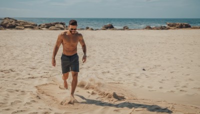 solo,short hair,black hair,1boy,navel,nipples,full body,male focus,outdoors,shorts,barefoot,day,water,muscular,facial hair,ocean,beach,abs,sunglasses,pectorals,muscular male,bara,beard,walking,topless male,running,rock,mustache,sand,male swimwear,swim trunks,footprints,sky,large pectorals,mature male,navel hair