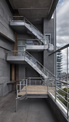 outdoors,sky,day,cloud,indoors,tree,blue sky,no humans,window,chair,cloudy sky,building,scenery,stairs,city,door,railing,cityscape,rooftop,balcony,air conditioner