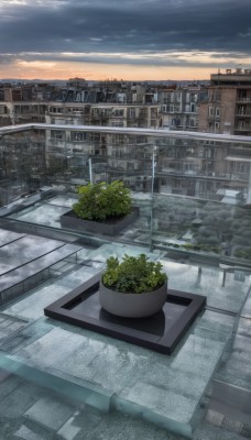 outdoors,sky,cloud,water,tree,no humans,window,sunlight,cloudy sky,plant,building,scenery,sunset,city,potted plant,road,cityscape,bridge,lamppost,street,skyscraper,day,blue sky