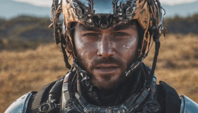 solo,looking at viewer,1boy,brown eyes,closed mouth,upper body,male focus,outdoors,day,armor,blurry,black eyes,blurry background,facial hair,helmet,portrait,beard,science fiction,mountain,realistic,stubble,straight-on,desert,brown hair,black hair,goggles,close-up,dirty