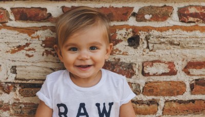 solo,looking at viewer,smile,short hair,open mouth,brown hair,shirt,1boy,white shirt,upper body,short sleeves,male focus,teeth,black eyes,t-shirt,child,realistic,male child,wall,brick wall,blue eyes,blonde hair,clothes writing