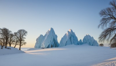 outdoors,sky,day,tree,blue sky,no humans,nature,scenery,snow,mountain,winter,bare tree,gradient sky,sunrise,footprints,shadow,ice,rock,sand,landscape,desert,frozen