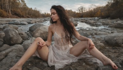 1girl,solo,long hair,breasts,brown hair,black hair,dress,holding,bare shoulders,brown eyes,jewelry,sitting,small breasts,outdoors,barefoot,day,spread legs,water,white dress,feet,tree,lips,wet,see-through,no bra,toes,looking away,ring,wet clothes,nature,forest,cigarette,rock,realistic,dirty,river,holding cigarette,see-through dress,dirty feet,medium breasts,sky,cloud,nail polish,bare legs,smoke,smoking,hand on own knee