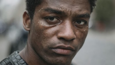 solo,looking at viewer,short hair,black hair,1boy,brown eyes,closed mouth,male focus,sweat,dark skin,blurry,black eyes,lips,depth of field,blurry background,facial hair,dark-skinned male,thick eyebrows,portrait,close-up,realistic