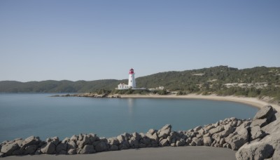 outdoors,sky,day,water,tree,blue sky,no humans,grass,building,nature,scenery,rock,mountain,sign,road,river,landscape,lake,shore,ocean,beach,forest,horizon,house,real world location,lighthouse