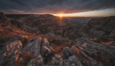 outdoors,sky,cloud,tree,no humans,sunlight,cloudy sky,nature,scenery,sunset,light rays,rock,mountain,sun,landscape,cliff,horizon