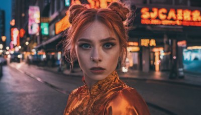 1girl,solo,looking at viewer,short hair,blue eyes,brown hair,jewelry,upper body,braid,earrings,outdoors,parted lips,hair bun,orange hair,blurry,lips,double bun,night,depth of field,blurry background,chinese clothes,portrait,freckles,city,realistic,nose,road,orange shirt,street,open mouth,bangs,teeth,parted bangs,building,city lights,neon lights