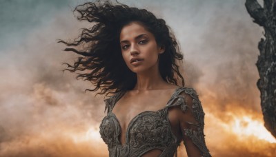 1girl,solo,long hair,breasts,looking at viewer,black hair,cleavage,brown eyes,medium breasts,collarbone,upper body,parted lips,sky,cloud,dark skin,armor,black eyes,dark-skinned female,lips,floating hair,fire,wind,messy hair,curly hair,realistic,cloudy sky,fantasy