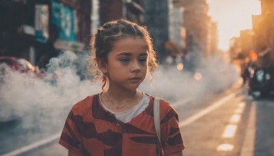 1girl,solo,short hair,shirt,black hair,jewelry,closed mouth,upper body,short sleeves,earrings,outdoors,striped,dark skin,necklace,bag,blurry,dark-skinned female,lips,depth of field,blurry background,ground vehicle,building,red shirt,child,motor vehicle,freckles,curly hair,striped shirt,city,realistic,nose,car,road,street,crosswalk,blue eyes,brown hair,day,sunlight,t-shirt