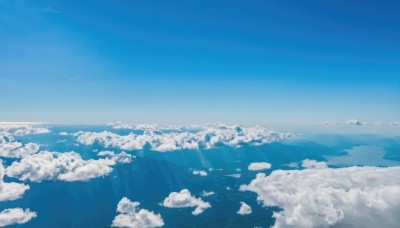 monochrome,outdoors,sky,day,cloud,water,blue sky,no humans,ocean,sunlight,cloudy sky,nature,scenery,blue theme,mountain,horizon,landscape,above clouds