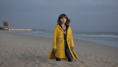 1girl,solo,looking at viewer,short hair,bangs,brown hair,shirt,long sleeves,brown eyes,closed mouth,standing,outdoors,open clothes,sky,pants,hood,medium hair,water,english text,lips,coat,black shirt,hoodie,ocean,beach,black pants,hood down,denim,wind,clothes writing,clenched hands,open coat,jeans,sand,arms at sides,horizon,watercraft,waves,shore,yellow coat,scenery,yellow jacket,raincoat,yellow raincoat