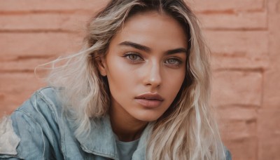 1girl,solo,long hair,looking at viewer,blonde hair,brown hair,shirt,brown eyes,jacket,upper body,parted lips,teeth,lips,grey eyes,eyelashes,thick eyebrows,denim,blue jacket,portrait,realistic,nose,brick wall,denim jacket,blurry,blurry background,close-up,forehead