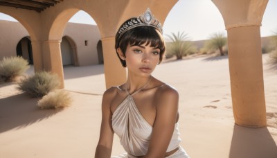 1girl,solo,breasts,looking at viewer,short hair,black hair,dress,bare shoulders,brown eyes,jewelry,medium breasts,collarbone,upper body,earrings,small breasts,outdoors,day,dark skin,white dress,dark-skinned female,lips,shadow,halterneck,tiara,realistic,very short hair,pillar,desert,bangs,brown hair,parted lips