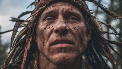 solo,long hair,looking at viewer,black hair,1boy,jewelry,closed mouth,male focus,outdoors,day,dark skin,blurry,black eyes,lips,depth of field,blurry background,facial hair,dark-skinned male,portrait,beard,realistic,dirty,dreadlocks,brown hair,close-up