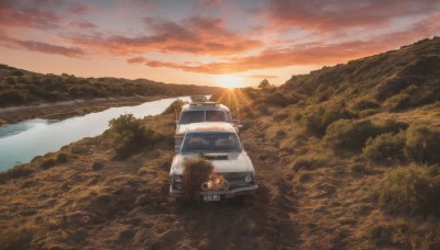 outdoors,sky,cloud,water,tree,no humans,sunlight,cloudy sky,grass,ground vehicle,nature,scenery,motor vehicle,forest,reflection,sunset,mountain,sun,car,road,vehicle focus,river,landscape,orange sky,ocean,horizon,evening,lake