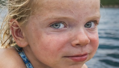 1girl,solo,looking at viewer,blonde hair,closed mouth,water,blurry,lips,grey eyes,blurry background,portrait,close-up,realistic,nose,jewelry,earrings,outdoors,eyelashes,freckles