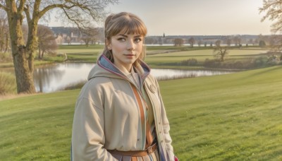 1girl,solo,long hair,looking at viewer,bangs,brown hair,shirt,long sleeves,brown eyes,jewelry,jacket,upper body,outdoors,parted lips,open clothes,day,belt,hood,water,tree,lips,coat,hood down,grass,building,scenery,realistic,nose,brown belt,river,lake,smile