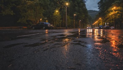 outdoors,sky,cloud,water,tree,no humans,night,cloudy sky,ground vehicle,building,nature,night sky,scenery,motor vehicle,reflection,car,light,road,bush,bridge,lamppost,street,river,forest,rain,realistic,dark,puddle,pavement,vanishing point