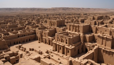 monochrome,outdoors,sky,day,blue sky,no humans,building,scenery,mountain,city,sand,horizon,road,cityscape,landscape,desert,beach,rock,ruins,sepia